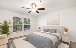 Fort Myers apartment for rent - A bedroom with a large bed and a ceiling fan.