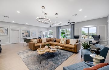 Fort Myers apartment for rent - A spacious living room with a large sectional sofa and a coffee table in the center.