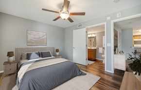 Cape Coral apartment for rent - A bedroom with a large bed and a ceiling fan.