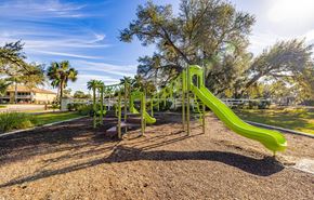Cape Coral apartment for rent - A playground with a green slide and a brown ground.
