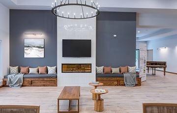 Fort Worth apartment for rent - A modern living room with a fireplace and a large painting on the wall.