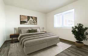 Albuquerque apartment for rent - A bedroom with a large bed and a potted plant.