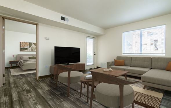 Albuquerque apartment for rent - A living room with a grey couch and a wooden table.
