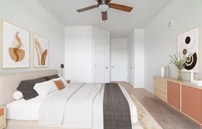 Denver apartment for rent - A bedroom with a large bed and a ceiling fan.