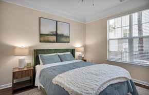 Durham apartment for rent - A bedroom with a large bed and two lamps on side tables.