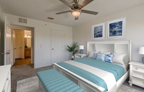 Cocoa apartment for rent - A bedroom with a large bed and a ceiling fan.