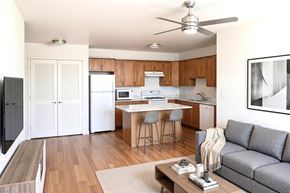 Vero Beach apartment for rent - A modern kitchen with a dining table and a grey sofa.