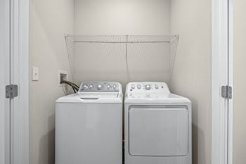 A washer and dryer in a laundry room with a white door