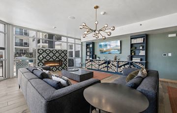 Denver apartment for rent - A modern living room with a grey sofa and a black coffee table.