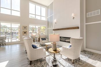 A living room with a fireplace and a large window.
