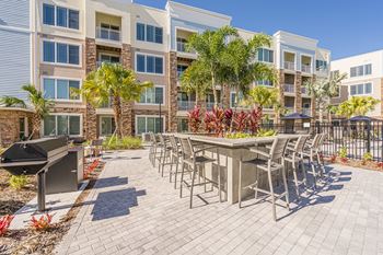 A patio area with a table and chairs in front of a building.