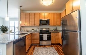 Parker apartment for rent - A kitchen with wooden cabinets and stainless steel appliances.