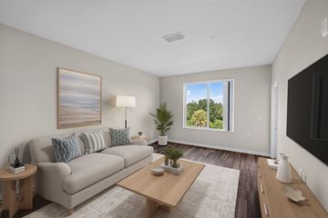 Apopka apartment for rent - A living room with a couch, a coffee table, and a painting on the wall.