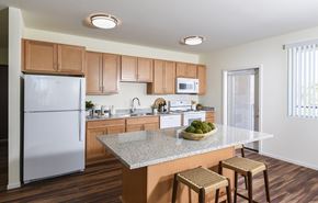 Goodyear apartment for rent - A Kitchen with Refrigerator at Suncrest Vista at Canyon Trails 55+ Apartments, Arizona, 85338