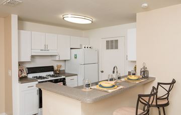 Port Orange apartment for rent - A kitchen with a table set for two.