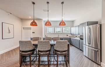 Garland apartment for rent - A kitchen with a table and chairs in the middle of it.
