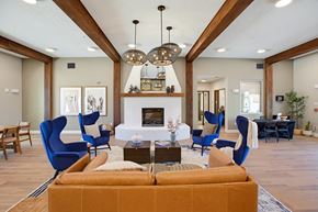 Rio Rancho apartment for rent - A living room with a fireplace and blue chairs.