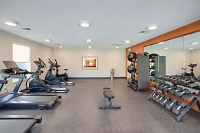 Rio Rancho apartment for rent - A gym with treadmills, exercise bikes, and weights.