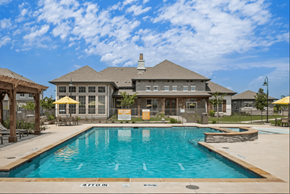 Waxahachie apartment for rent - a large swimming pool in front of a house at Five 49 at River Oaks, Waxahachie, TX 75165