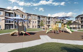 Austin apartment for rent - A playground area with slides and swings in front of apartment buildings at Sage at Franklin Park Apartment , Texas, 78744