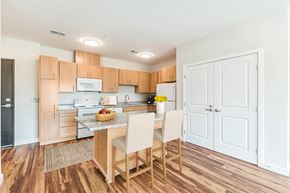 Greenville apartment for rent - A kitchen with wooden floors and white walls. at Avery Landing Apartments, Greenville, SC