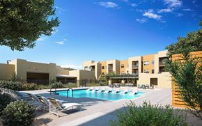 Rio Rancho apartment for rent - A pool area with sun loungers and a building in the background at Sandoval Flats Apartment , Rio Rancho, MN