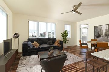 Rio Rancho apartment for rent - A living room with a black couch and a television.