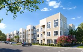 Apopka apartment for rent - A row of modern apartment buildings with cars parked in front at The Mira Apartments, Apopka 32712