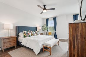 Canton townhouse for rent - A bedroom with a large bed and a wooden dresser.