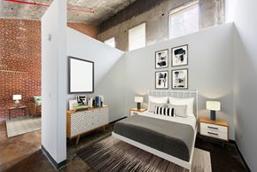 Atlanta apartment for rent - A bedroom with a bed, nightstands, and pictures on the wall.