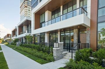 Coquitlam apartment for rent - A modern building with a balcony and a walkway in front.