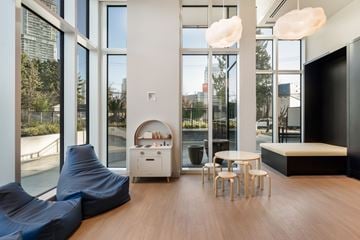 Coquitlam apartment for rent - A modern living room with a blue bean bag chair and a white side table.