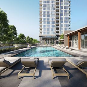 Coquitlam apartment for rent - A pool with sun loungers and a building in the background.