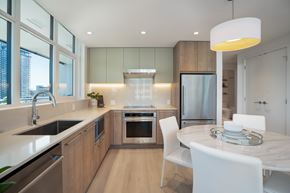Coquitlam apartment for rent - A modern kitchen with a dining table and chairs.
