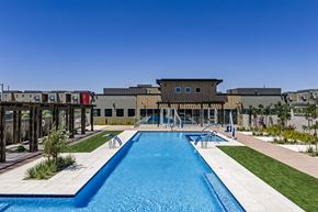 Avondale apartment for rent - A swimming pool in front of a building with a clear blue sky.