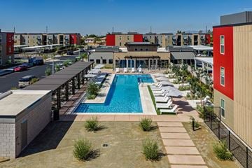 Avondale apartment for rent - A pool surrounded by a concrete patio and a black fence.