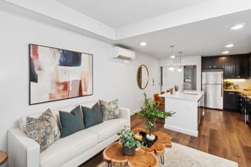 Marble Falls apartment for rent - A living room with a white couch and a painting on the wall.
