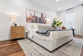 Marble Falls apartment for rent - A bedroom with a large bed, a wooden nightstand, and a rug on the floor.