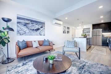 Avondale apartment for rent - A living room with a brown couch and a coffee table.