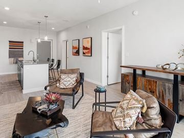Phoenix apartment for rent - A living room with a brown couch and a coffee table.