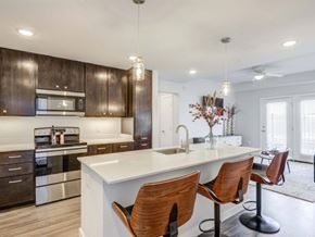 Maricopa apartment for rent - Flatz 520 furnished kitchen model, ceiling lighting, barstool chairs, cabinet space, stainless steel appliances, hardwood floors
