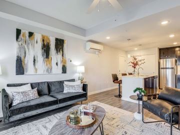 Maricopa apartment for rent - A modern living room with a black couch and a coffee table.
