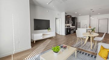 Midland apartment for rent - A modern living room with a white sofa and a television.