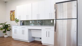Kitchen with refrigerator in community room