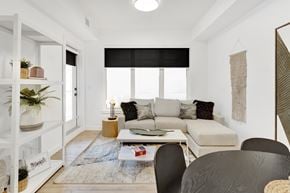 Calgary apartment for rent - A living room with a couch, a coffee table, and a rug.