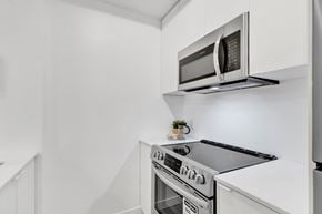Calgary apartment for rent - A modern kitchen with a stove and microwave.
