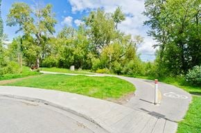 Calgary apartment for rent - A bike lane is marked on the road with a bicycle symbol and a red post.