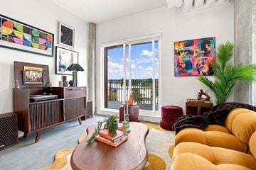 Calgary apartment for rent - A living room with a brown wooden table and a yellow sofa.