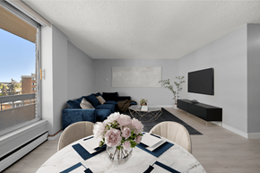 Calgary apartment for rent - A dining room with a table set for two with a vase of flowers on it.