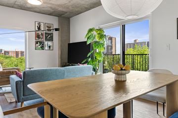 Edmonton apartment for rent - A living room with a blue couch and a wooden table.